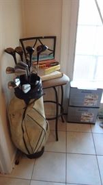 Golf clubs, cook books, glasses new in box, kitchen stool. 