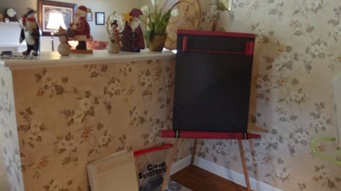 Vintage child's easel, Rembrandt book, scrapbooking materials, assorted Christmas decorations. 