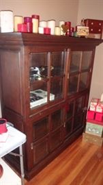 Gorgeous vintage oak bookcase or china cabinet with sliding doors.   Lots of assorted candles on top.    