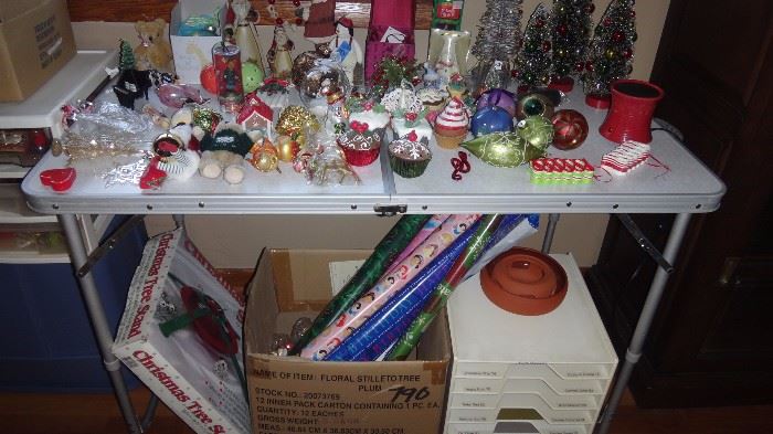 Table top and drawers and boxes of ornaments.    All types.   Christmas tree base.   Shelving unit for scrapbookings materials.    Wrapping paper rolls. 