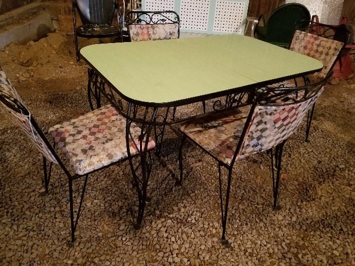 green formica and black wrought iron table and 4 chairs