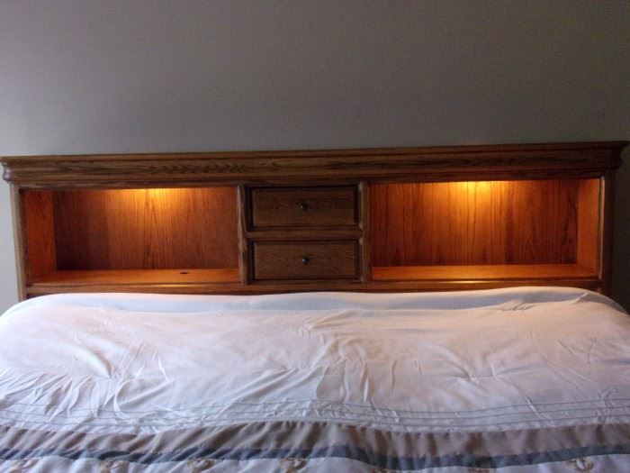 Stunning oak King captain bed with four drawers, book shelf head board and matching amoire(mattress and box springs not for sale)