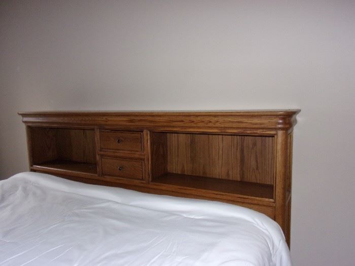 Stunning oak King captain bed with four drawers, book shelf head board and matching amoire(mattress and box springs not for sale)