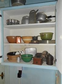 Stoneware mixing bowls, coffee grinders, hand mixers, tin pans.