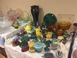 An amazing collection of ceramic flower frogs.