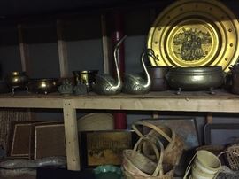 Brass and copper pots, swans and planters.