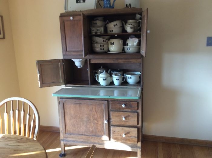 Beautiful Hoosier cabinet in great condition and full of silhouette china