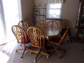 Oak table and 8 chairs on wheels/castors