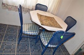 Metal chairs with caning and picnic blue checkered padded chairs and octagon table