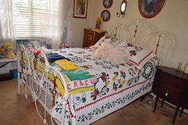 White wrought iron bed with comforter