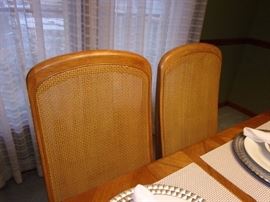 Dining room table with 6 wicker back chairs(2 captain not pictured and china cabinet