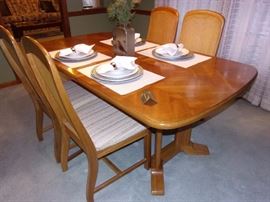 Dining room table with 6 wicker back chairs(2 captain not pictured and china cabinet