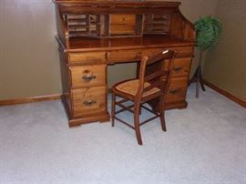 Oak roll top desk and cane seated chair