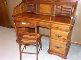 Oak roll top desk and cane seated chair