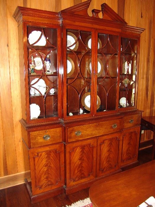 Handsome semi-antique  Kittenger mahogany breakfront secretary  with bubble glass doors, brass pulls and open pediment