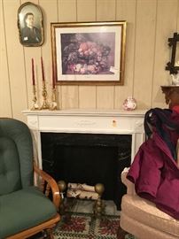 Fireplace mantle & andirons, brass candlesticks, pictures.