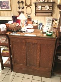 Front side of sales counter with glass top (shelves and locking cash drawer on other side),