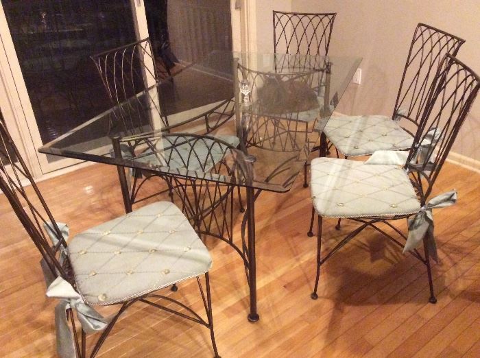 Vintage wrought iron patio set. Glass top table, 5 chairs and 2 bar stools that match