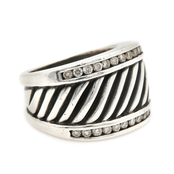 David Yurman Sterling Silver Diamond Ring: A David Yurman sterling silver diamond ring. This ring features a center beveled setting bordered by two channel set diamond rows.