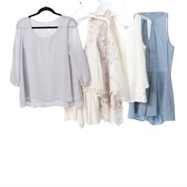 Women's Rompers and Tops Including Bar III: A five piece group of women’s rompers and tops, size small and medium. The three tops include a Bar III layered cream tank top in rayon chiffon; a Judith March sleeveless white lace top with a tan underlay, and a Love Notes light gray layered top with three quarter sleeves. Also featured are two rompers; in blue from Fab’ rik, and in white with pompom trim from Karlie.