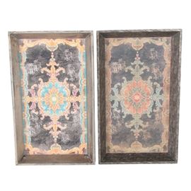Decorative Painted Wood Trays:A pair of decorative painted wood trays. The trays are decorated with a central medallion with pendants to all four sides in a palette of blue and orange on a dark brown ground. Each has an intentionally distressed finish.