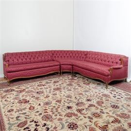 Vintage Sectional Sleeper Sofa: A vintage sectional sleeper sofa featuring three individual sections including two sofas, each with a single arm rest and an corner unit. Each section has a button tufted back over removable seat cushions and exposed maple trim. The sofa pieces are covered in a tone-on-tone rose colored fabric with a flame pattern and stand on short, cabriole legs. The longer sections have scalloped aprons and the corner piece has an arched apron with scalloped side aprons. One section is fitted with a queen size fold-out mattress from General Steel Products and dated July 9, 1969 and marked “Sure-Lock.