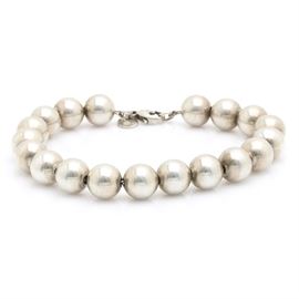 Tiffany & Co. Sterling Silver "Tiffany Beads" Bracelet: A Tiffany & Co. sterling silver bracelet from the Tiffany Beads collection. This bracelet features a strand of nineteen sterling silver beads with a lobster claw clasp.
