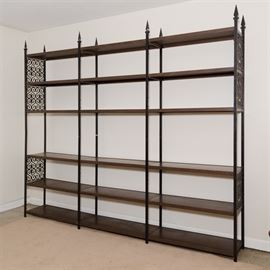 Gothic Style Metal and Wood Shelving Unit: A large metal and wood shelving unit. The metal frame features Gothic details in its pointed finials and scroll work grills at the ends of the shelves. There are three bays with six shelves.