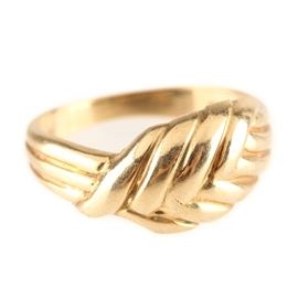 14K Yellow Gold Ring: A 14K yellow gold ring. This ring features grooves that create a braided appearance.