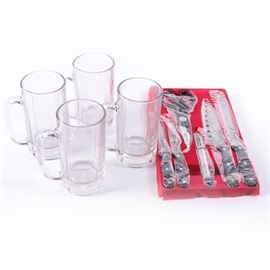 Japanese Cutlery Set and Glass Beer Steins: A four piece set of glass beer steins and a set of Japanese cutlery. The classic glass steins feature fluted detail to the body with a solid glass handles. They are not visibly marked and are presented in their original box. The cutlery set is also in it’s original box, marked Genichi Shimada, as are the blades. Included in the seven piece set are kitchen scissors, a peeler, a chef’s knife, a serrated knife and two smaller kitchen knives.