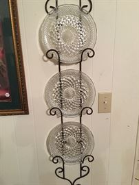 One of several plate racks, wrought iron, with plates
