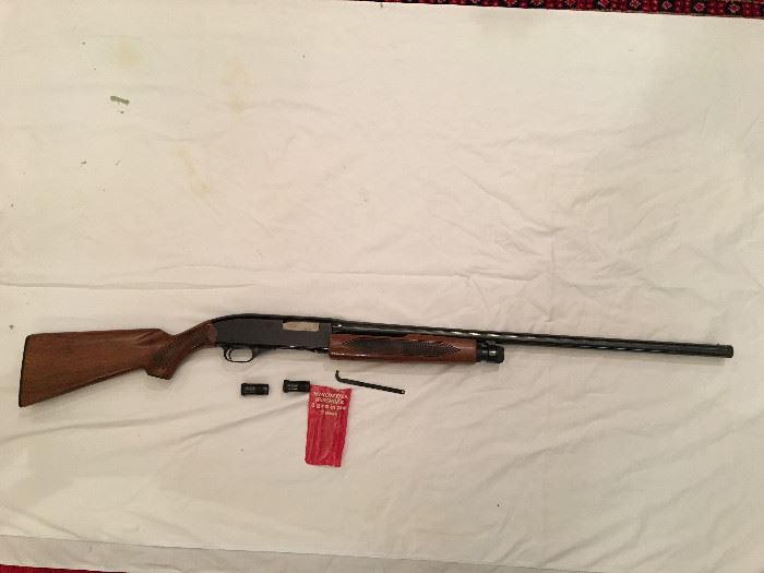 This is a Winchester Model 1200 - 12 gauge shotgun with extra chokes.