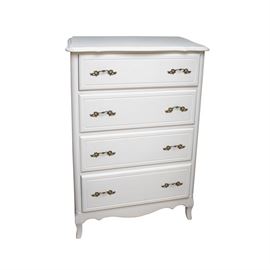 French Provincial Style Painted Chest of Drawers: A French Provincial style painted chest of drawers. This piece features a rectangular top with scalloped edge overhanging panel sides, rounded stiles and four drawers including decorative pulls and machine dovetailed joints. The piece includes a scalloped apron, cabriole legs and is finished in an off-white tone.