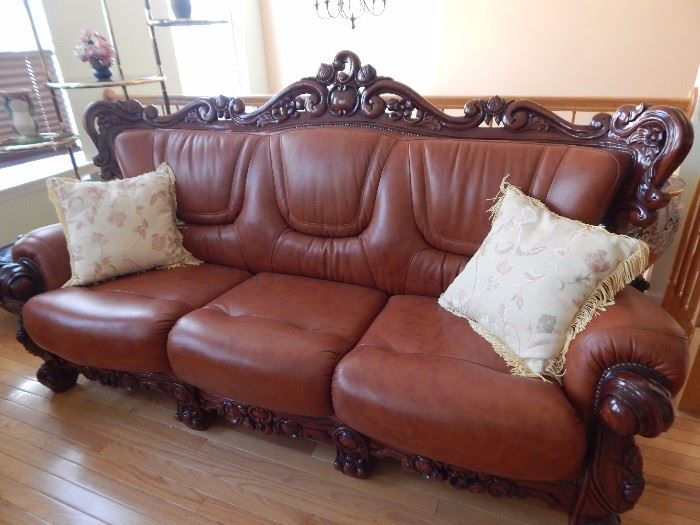 Three cushion leather sofa with carved wooden frame. Well made and in excellent condition.