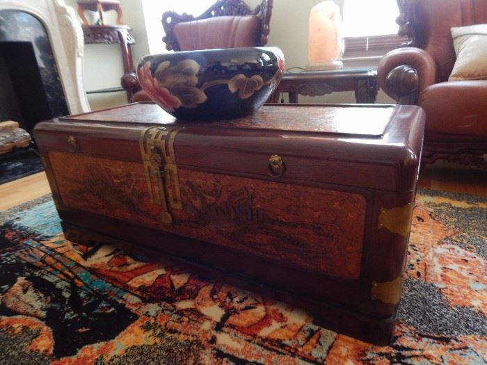 Large Asian chest with carving. Very ornate...decorated on top and sides. Brass accent as well.
