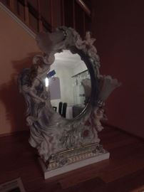 Table mirror with  ornate frame and lighting.