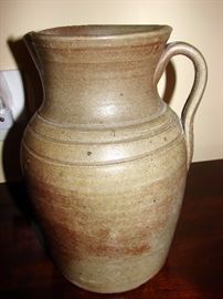 Earthen ware jug. This piece is said to have been made by slaves come from a Plantation.  There is some paperwork inside about the descendant of the plantation owners who originally had this prior to her death