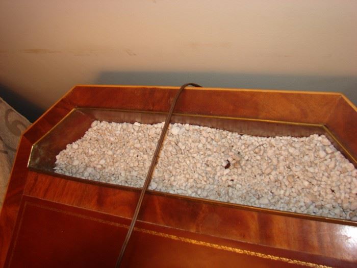 have  you ever seen an end table with pebbles in it!  It was designed to grow plants 