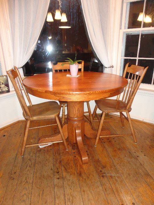 Sturdy oak kitchen table with six chairs.