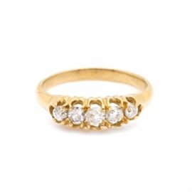 Victorian 18K Yellow Gold Diamond Ring: A Victorian 18K yellow gold diamond ring. This ring features a row of five old European cut diamonds held in a scalloped prong setting.