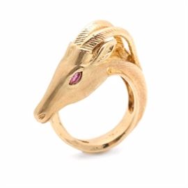14K Yellow Gold and Ruby Antelope Ring: A 14K yellow gold and ruby antelope ring. This ring features bypassing shoulders showcasing an antelope head with two rubies stylized as the eyes. The ring features etched detail through the horns and all throughout the shank. The shank is beveled for the appearance and representation of the antelopes body.