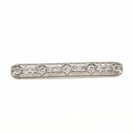 Edwardian Platinum 1.02 CTW Diamond Brooch: A Edwardian platinum brooch showcasing four diamonds alternating with twelve diamonds adorned across the delicate tracery openwork design.