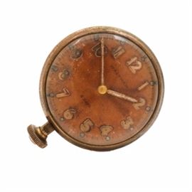 Waltham Brass 8 Day Car Clock: A Waltham brass 8 day car clock. This large car clock features a brass case, which houses a light brown dial, with brass tone Arabic numerals and hands.