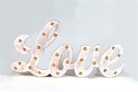 Metal "Love" Marquee Sign: A metal marquee sign. The sign, painted white with yellow light bulbs, depicts the word “Love” in cursive. Lights up via pluggable power cord.