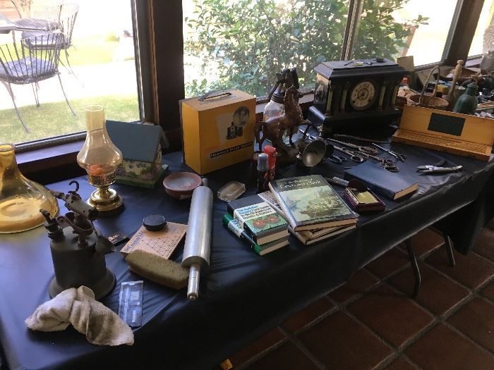 Old projector, mantle clock, books, kerosene lamps, steel rolling pin, bird house, tools & more...