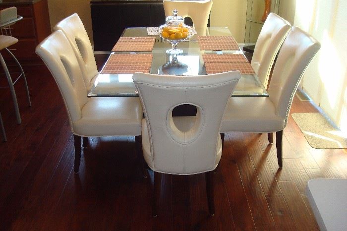 Modern glass top pedestal table and six chairs by Home Elegance.