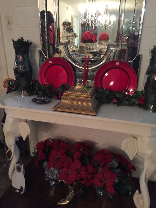 Red chargers, decorative poinsettias, mirror, hurricane lamps