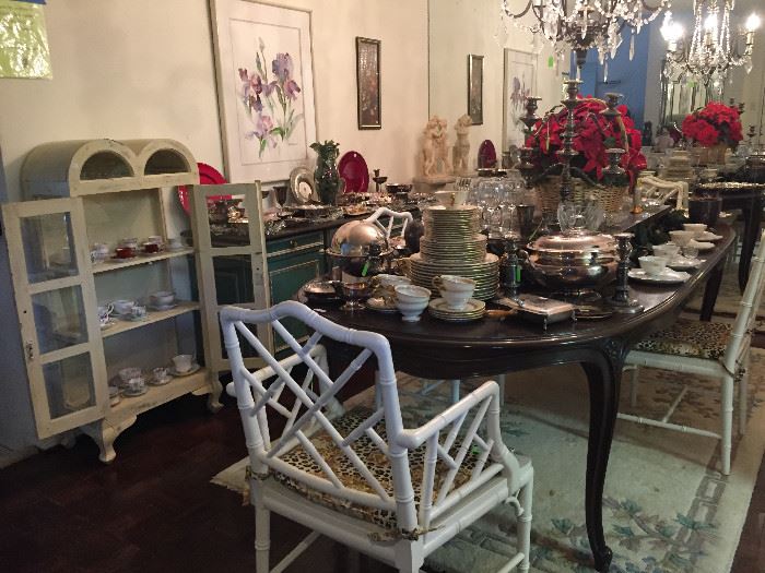 Dining table with vintage bamboo style dining chairs, silver plate, shabby chic curio cabinet, china and lots of crystal 