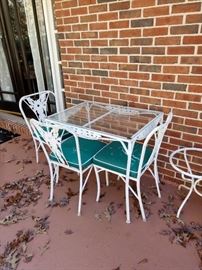 There are 4 chairs one not pictured here, great vintage outdoor table and chairs