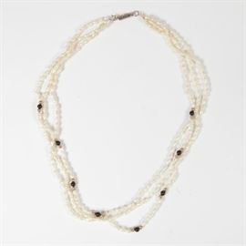 Multi-Strand Freshwater Pearl and Onyx Necklace with 14K Gold: A three strand freshwater pearl necklace embellished with onyx and gold tone beads. It finishes with a 14K gold barrel closure.